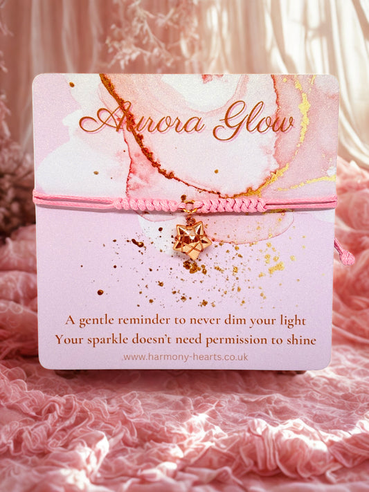 Harrmony Hearts branded card with a pink cord bracelet and glass star