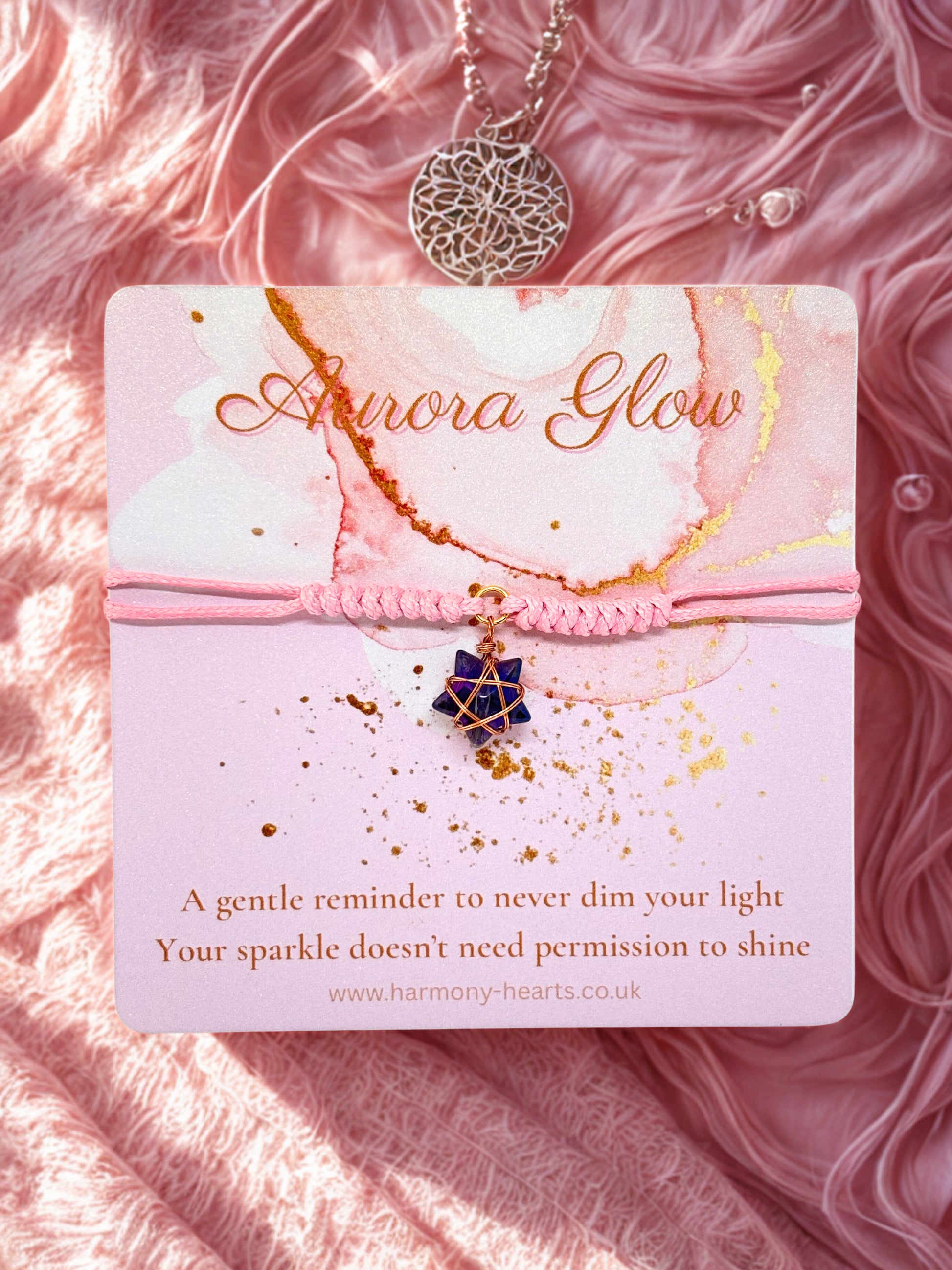 Pink cord bracelet with star charm presented on a Harmony Hearts branded card