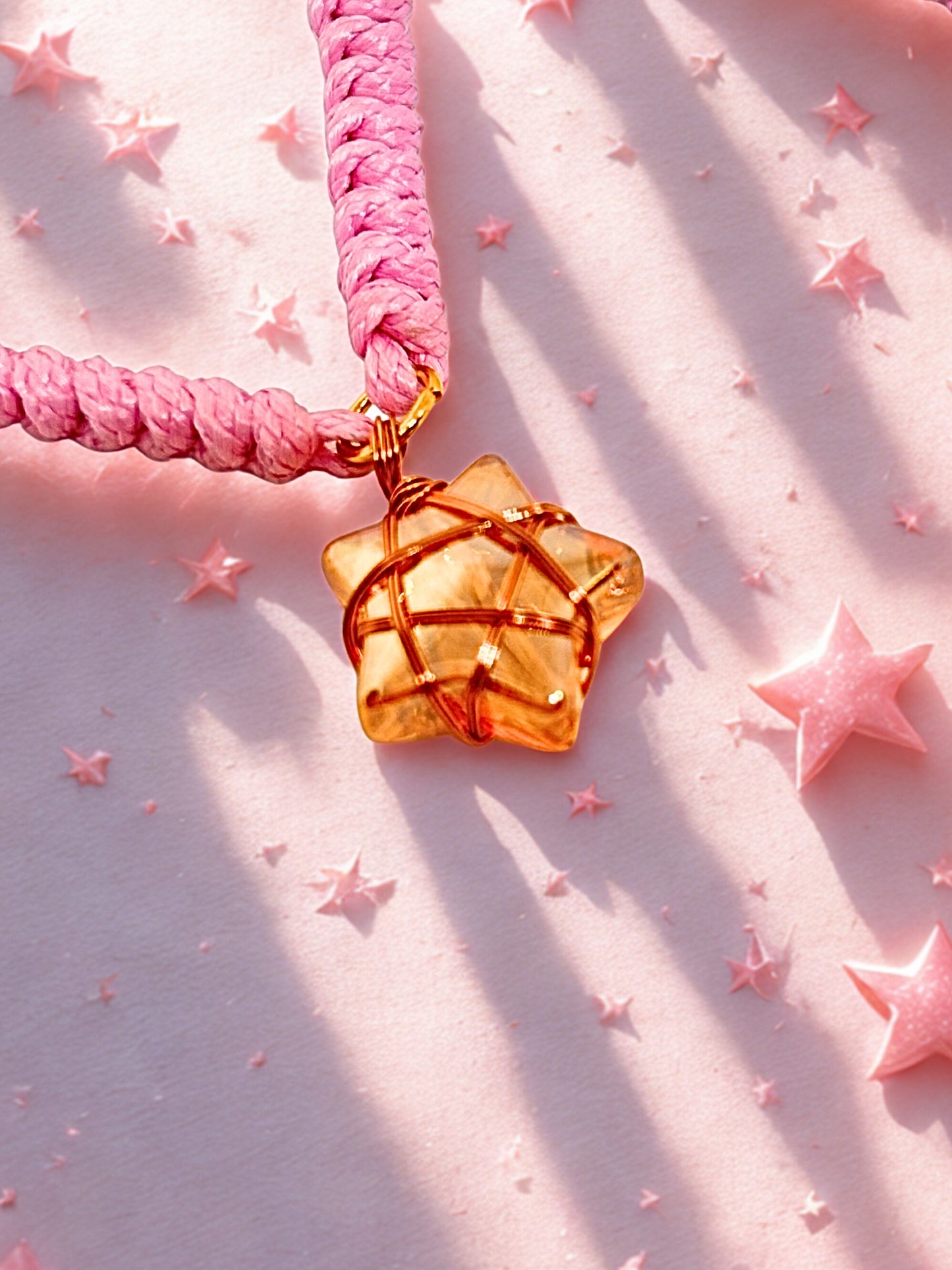 Pink cord bracelet with a wire wrapped star charm