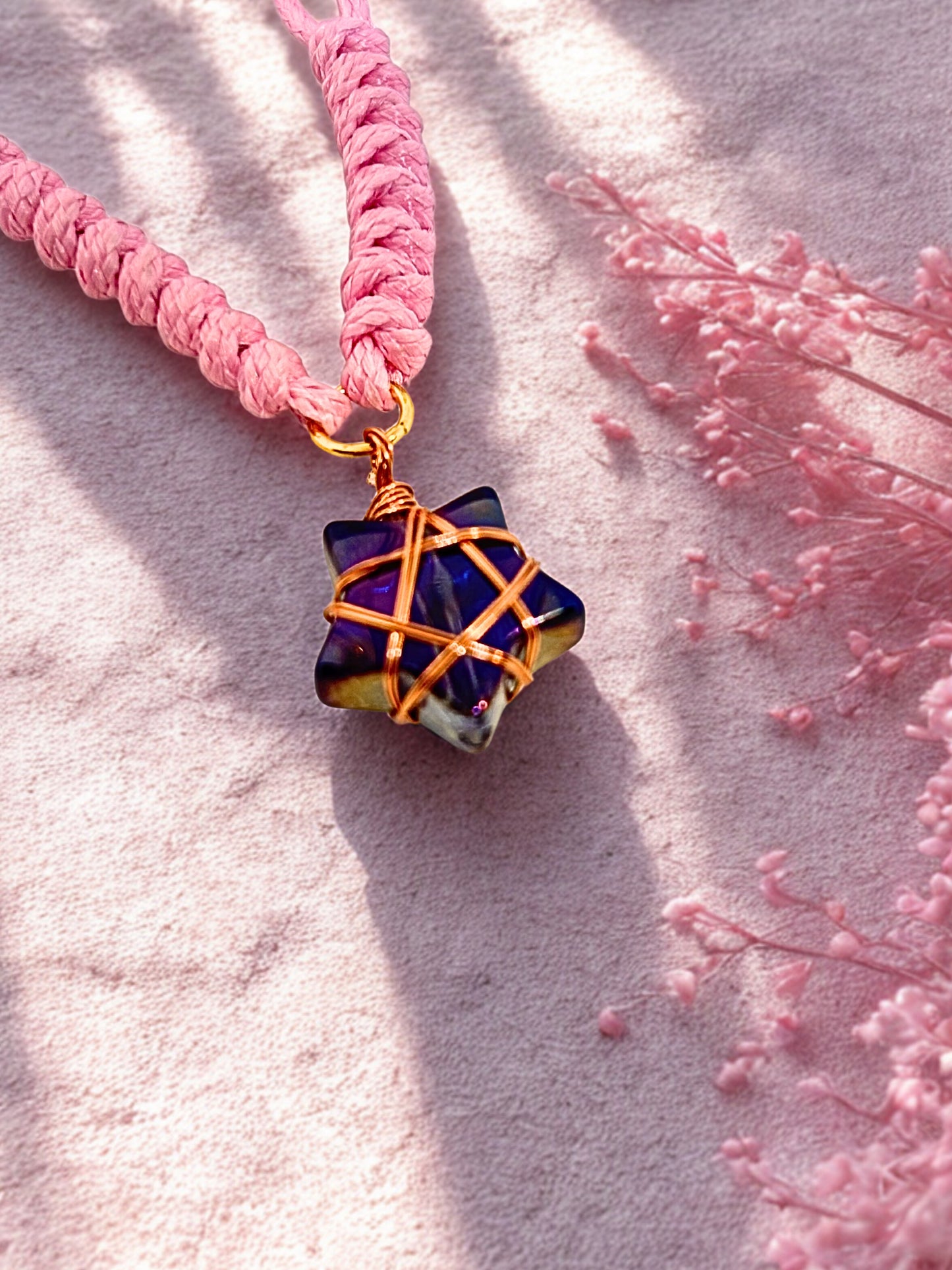 Pink cord bracelet with a star charm wrapped in rose gold wire