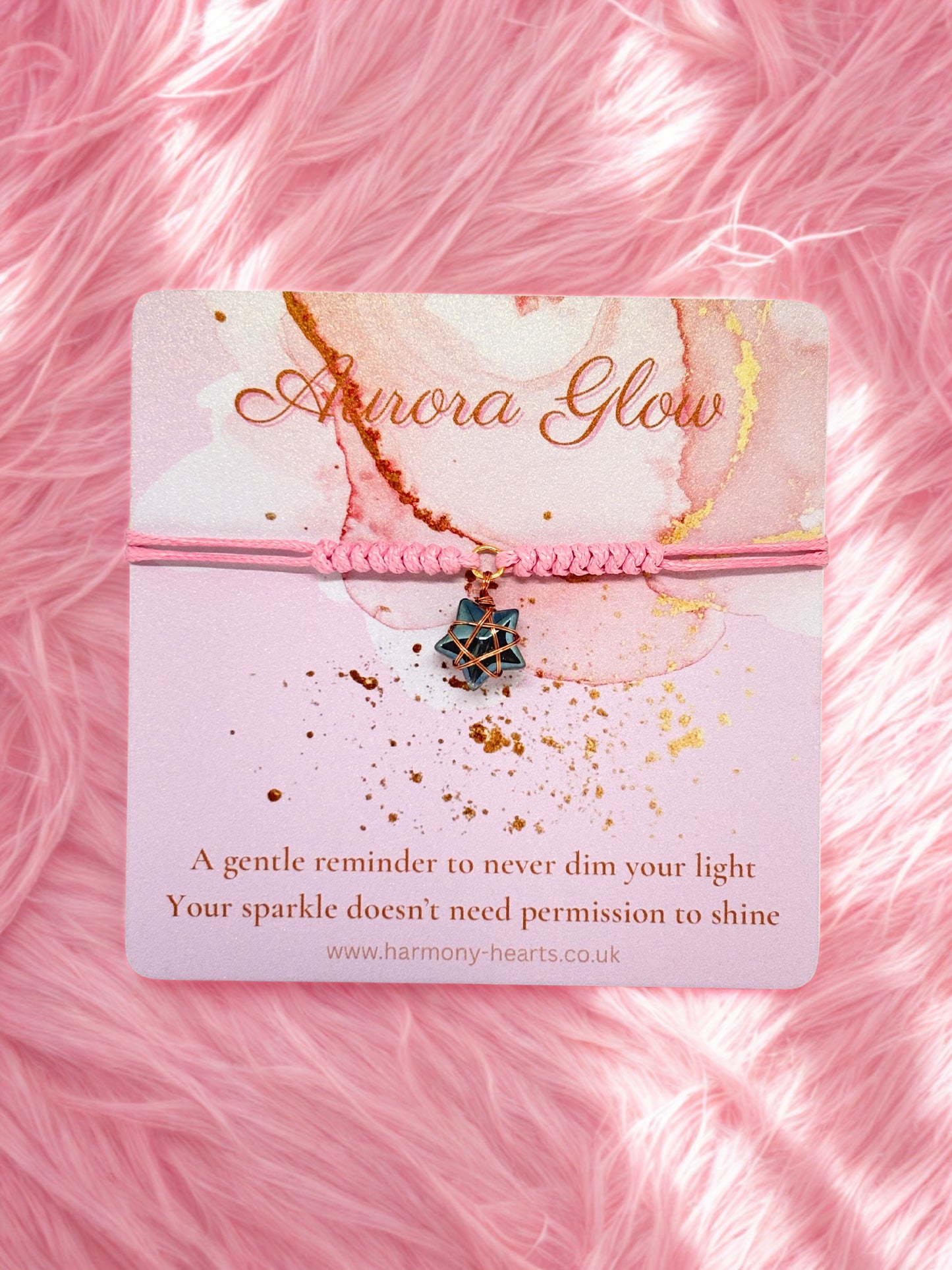 Star charm bracelet presented on a Harmony Hearts branded card on a pink textured background