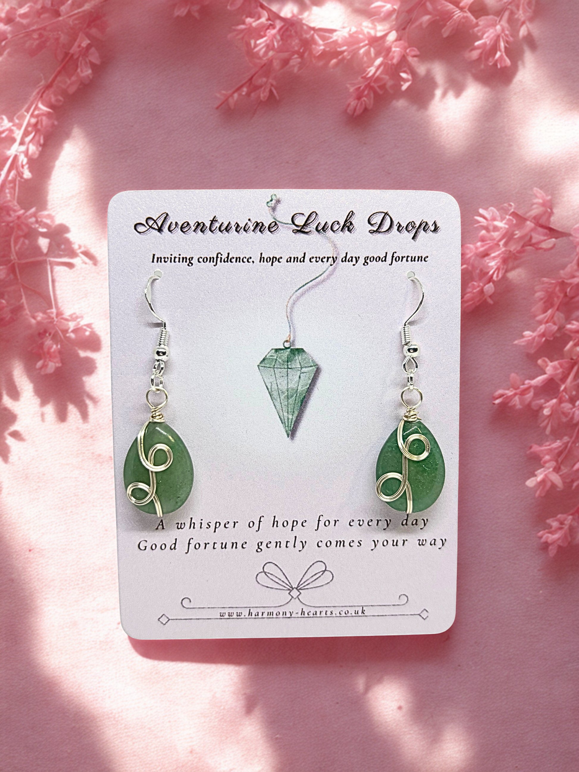 Green aventurine earrings on a card with pink floral background