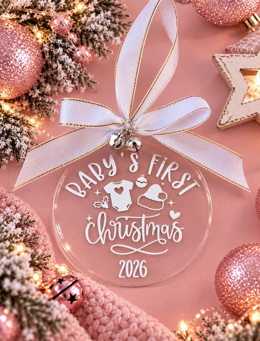 Round acrylic Christmas bauble, personalised with Baby’s First Christmas with silver charms and white satin ribbon