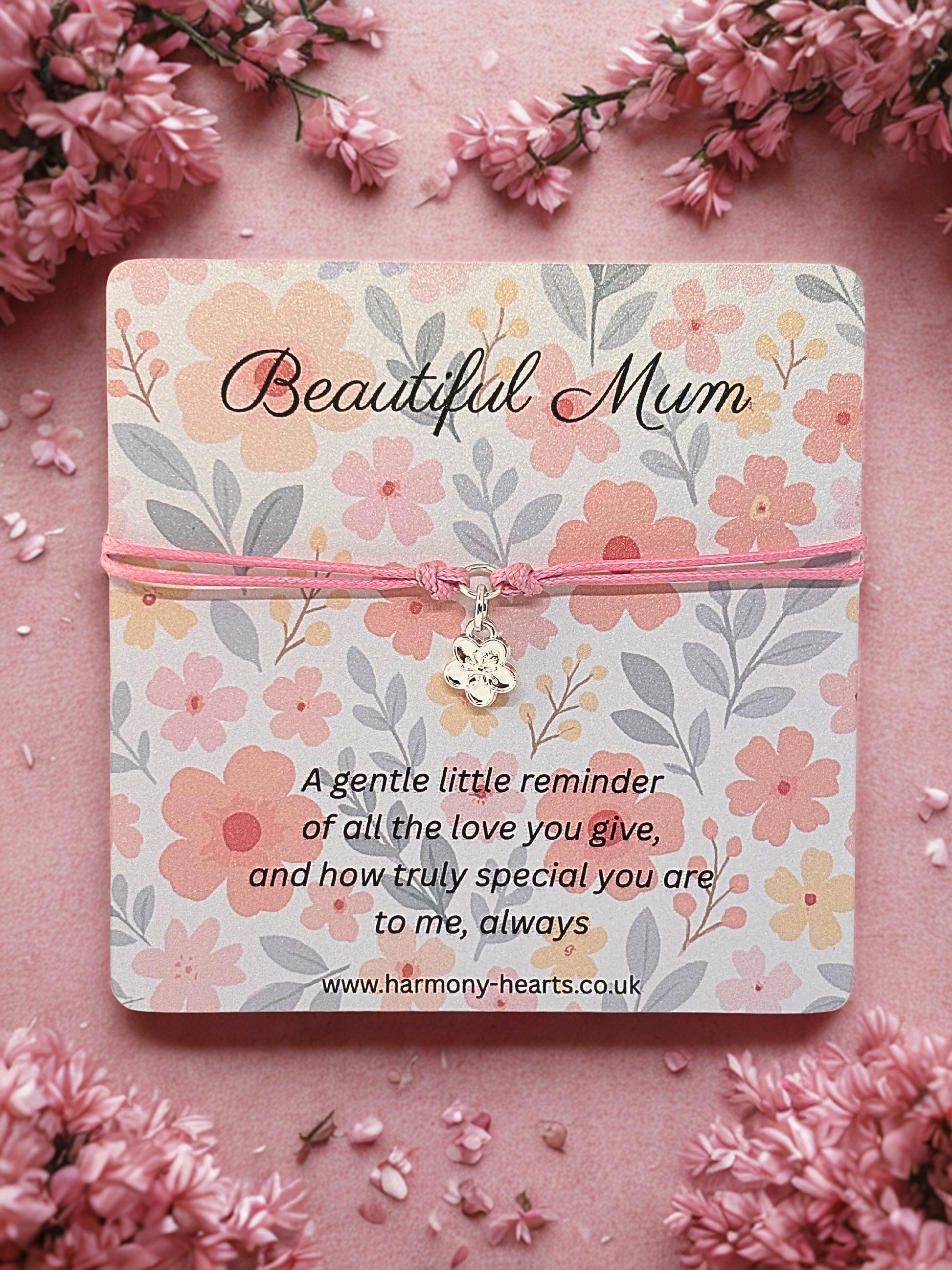 Floral card with 'Beautiful Mum' text and a flower charm bracelet on a pink background with flowers.