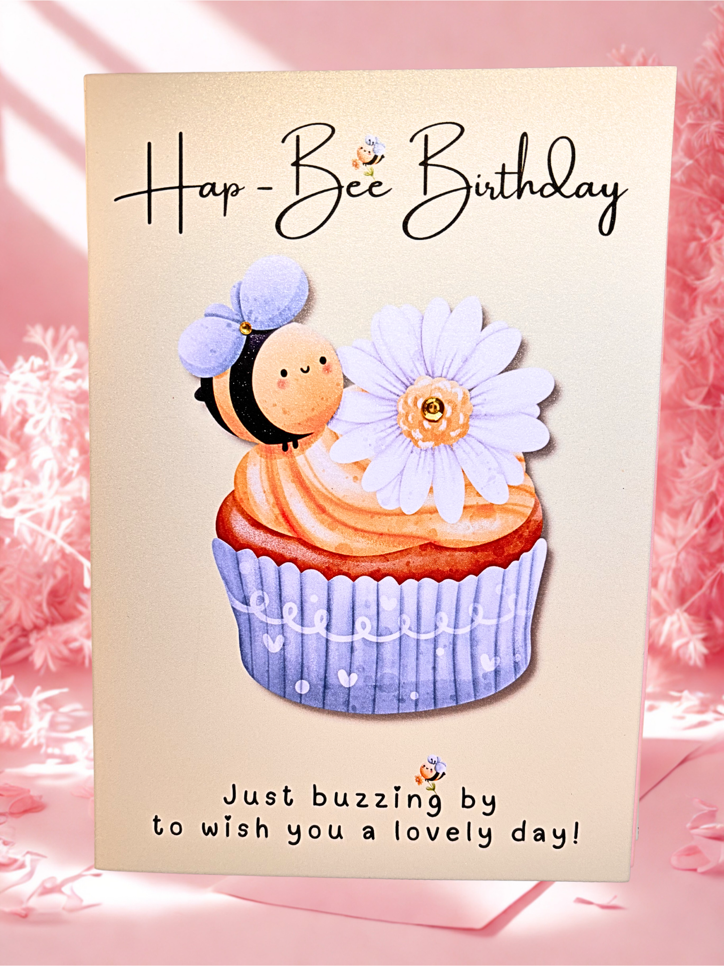 Birthday card with a bee character and cupcake illustration on a pink background