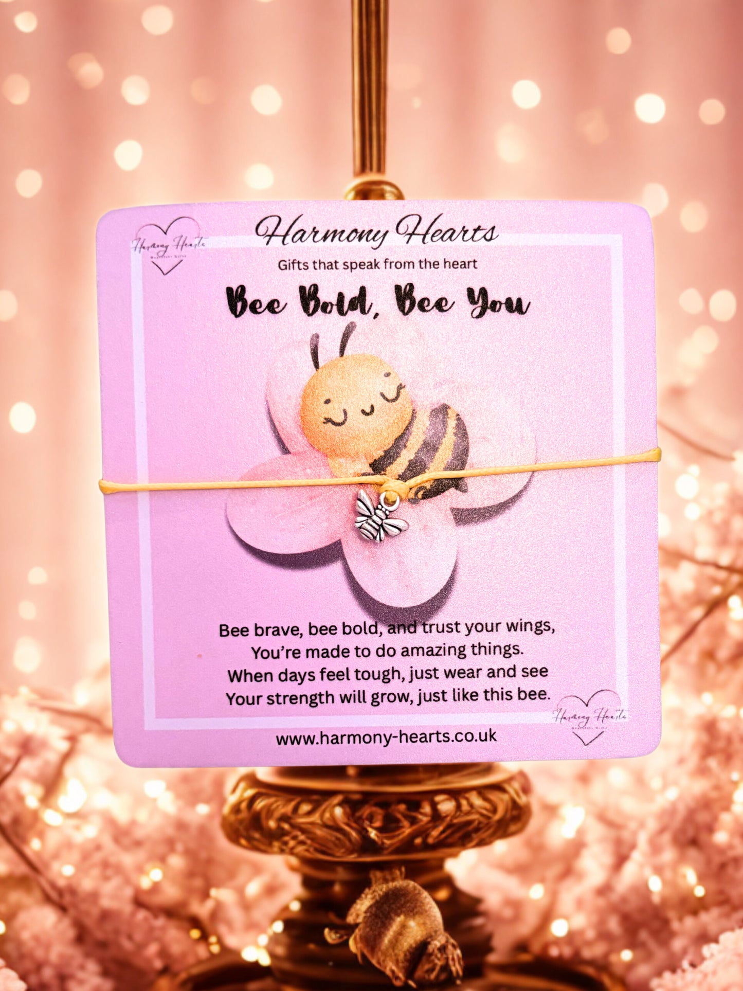 Bee-themed jewellery card and bracelet with motivational message on a pink background