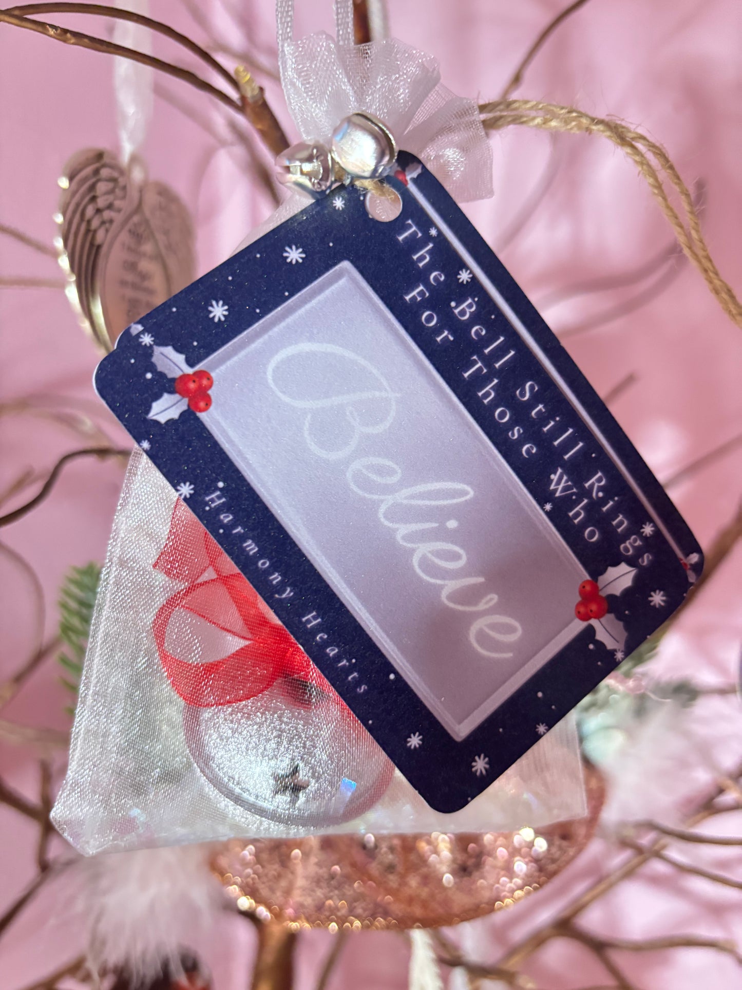Decorative tag with 'Believe' text on a pink background