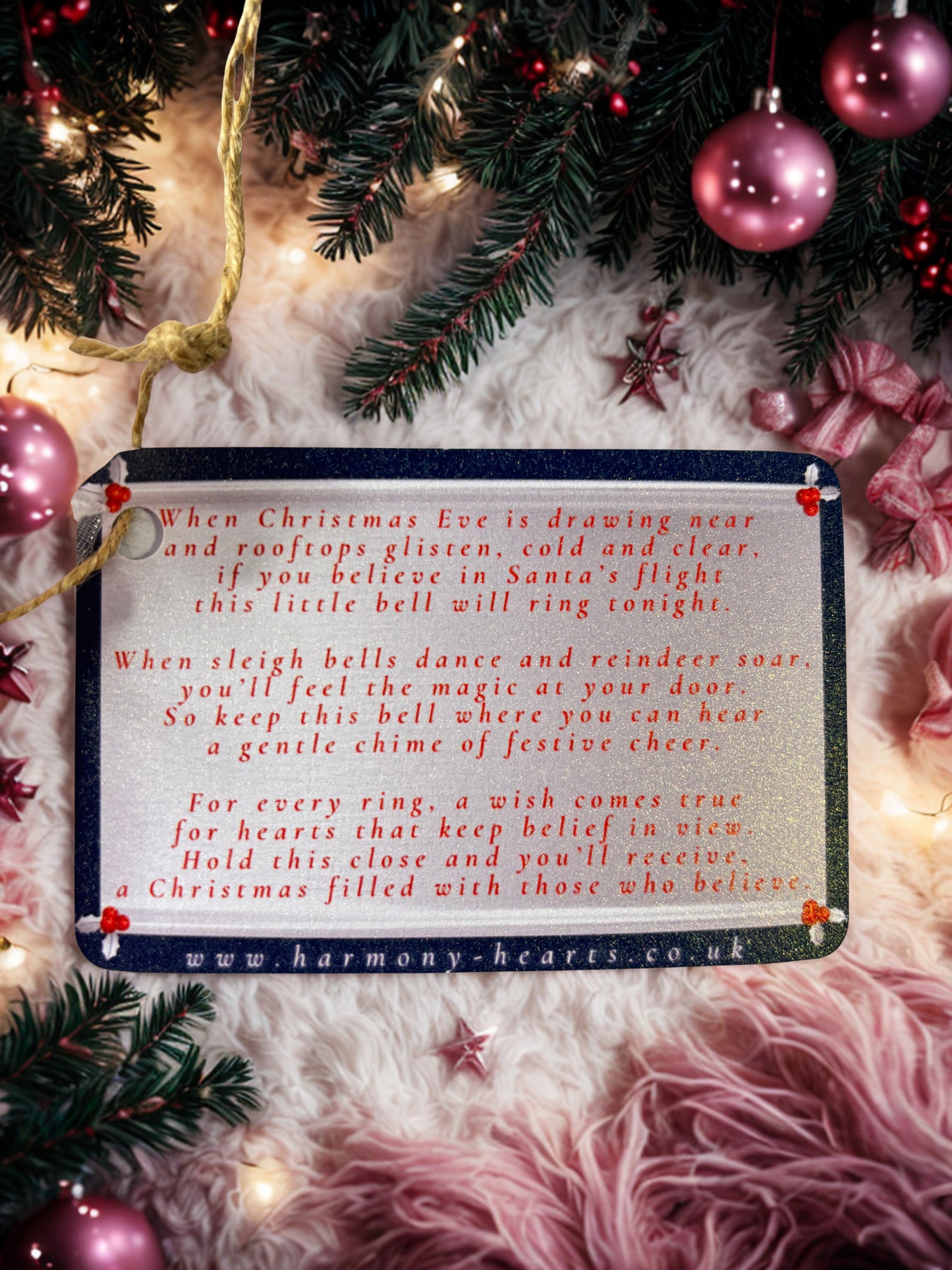Christmas-themed card with text and festive decorations on a soft pink background