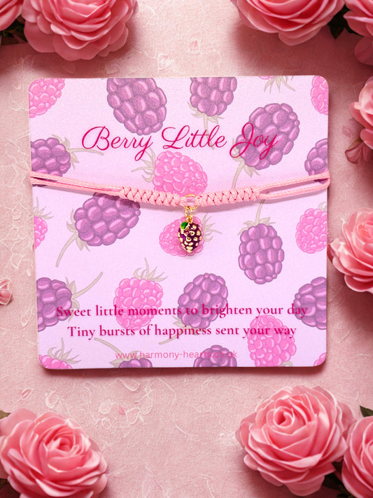 Pink cord bracelet with a blackberry charm presented on a Harmony Hearts branded poem card