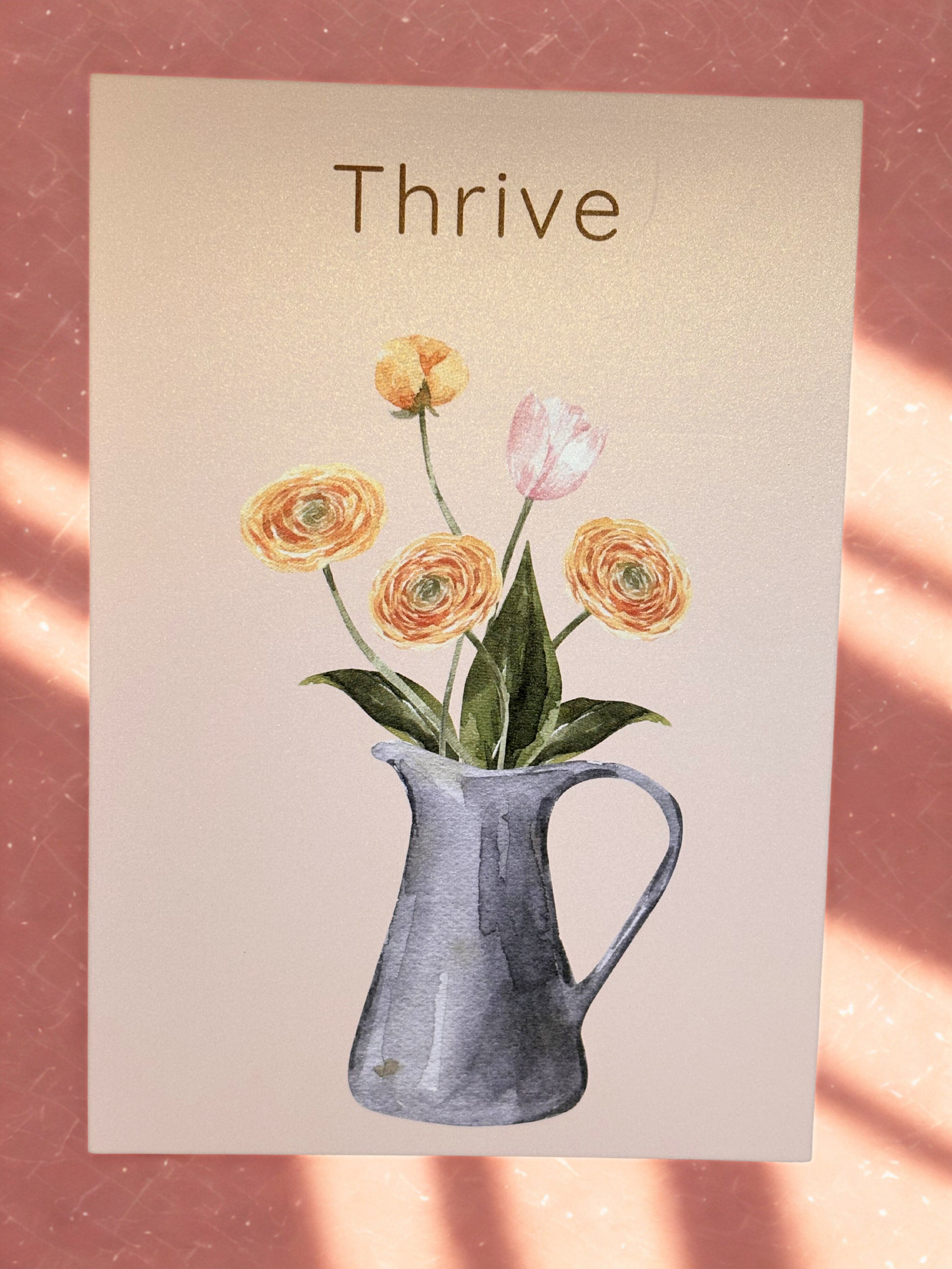 Print with flowers in a pitcher and 'Thrive' text on a beige background