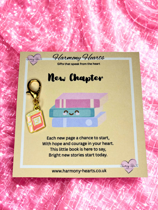 Book-themed charm on a 'Harmony Hearts' card with a pink textured background