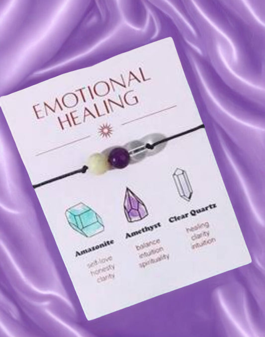 Emotional Healing bracelet packaging with crystals on a purple fabric background