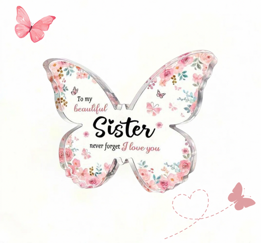 Butterfly-shaped plaque with floral design and text for a sister on a white background