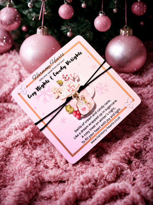 Bracelet on a Pink card with candy-themed design on a pink textured surface with Christmas ornaments.
