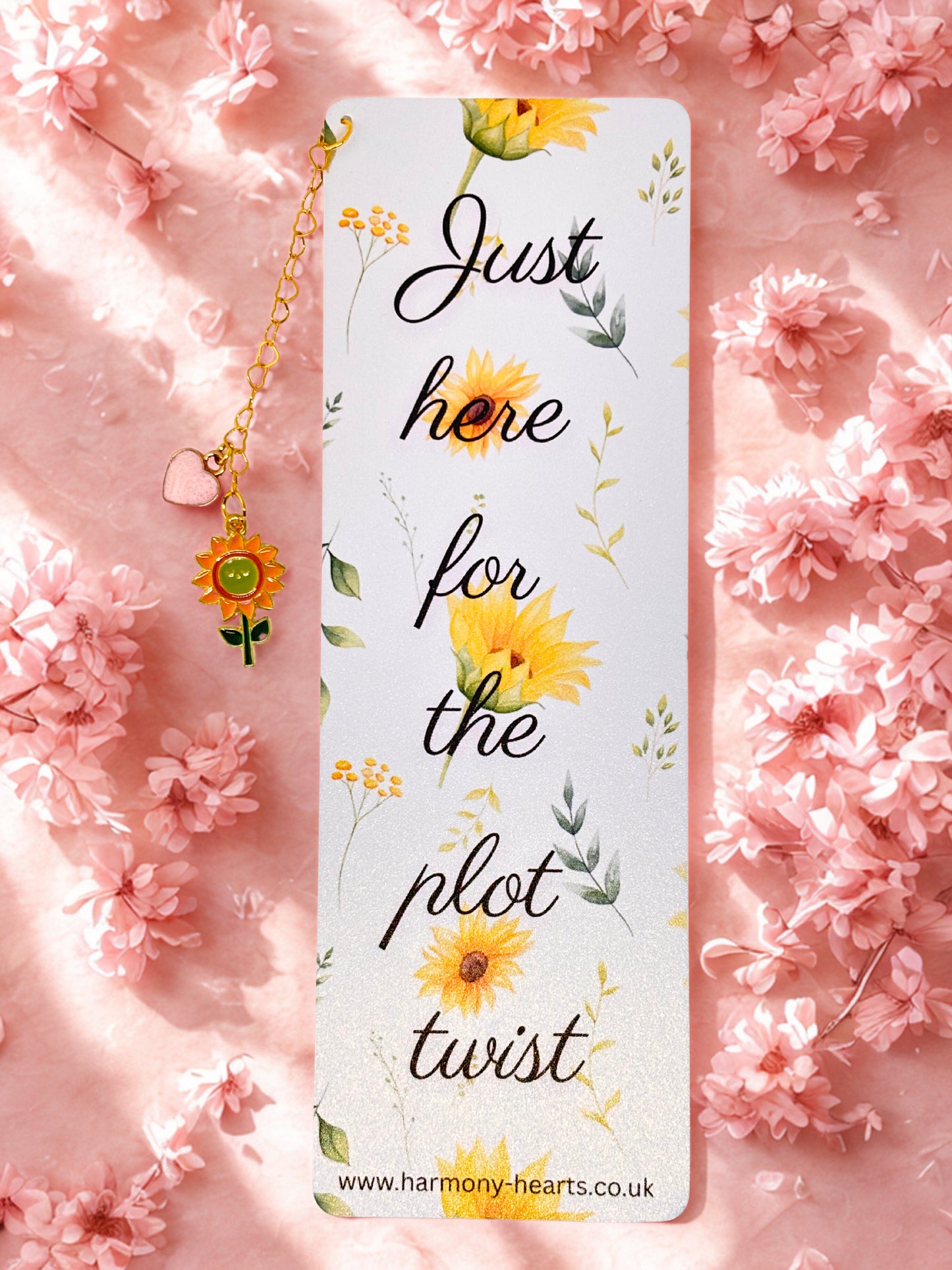 Bookmark with sunflower design and text 'Just here for the plot twist' on a pink floral background