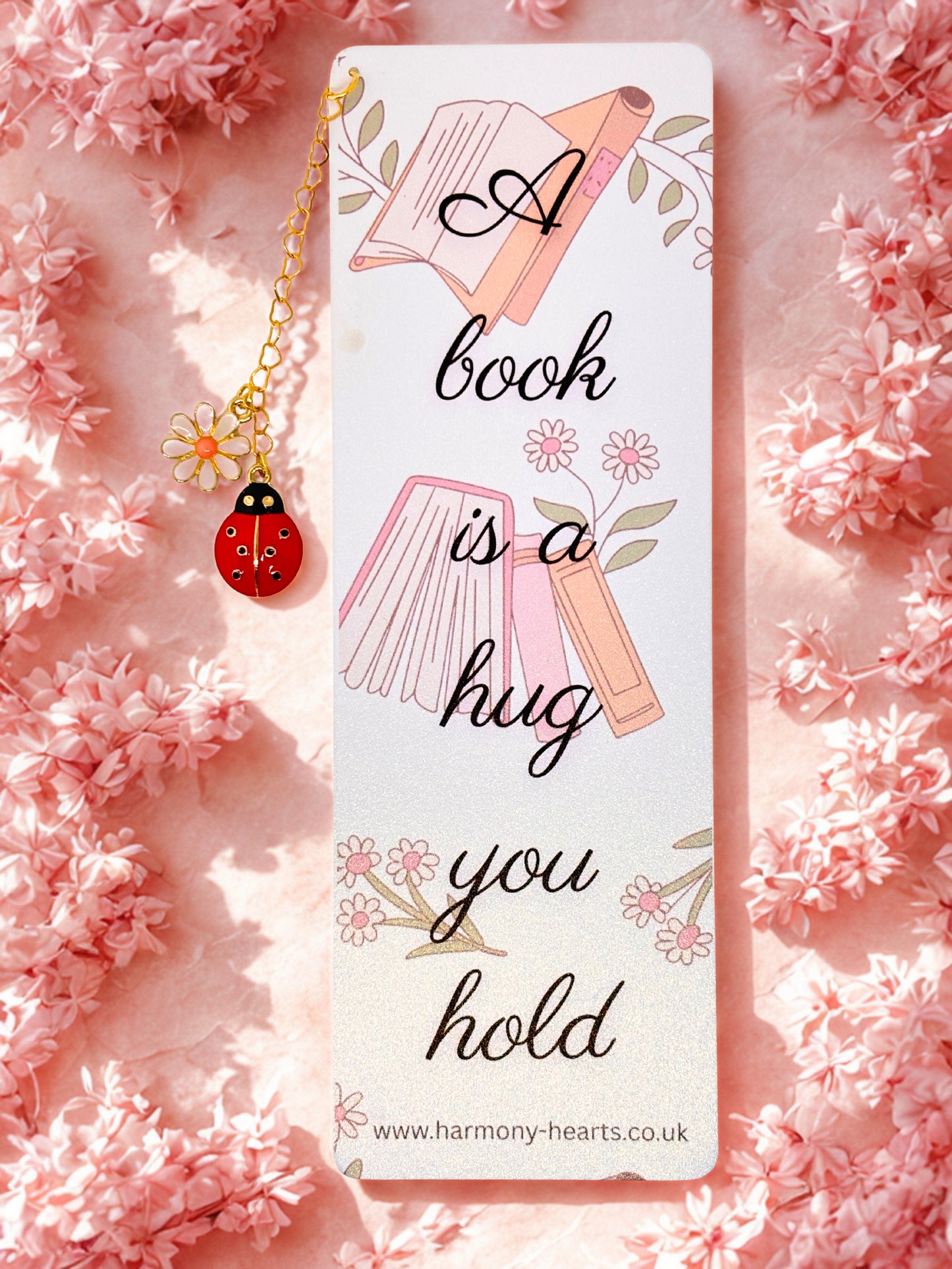 Bookmark with decorative elements on a pink floral background