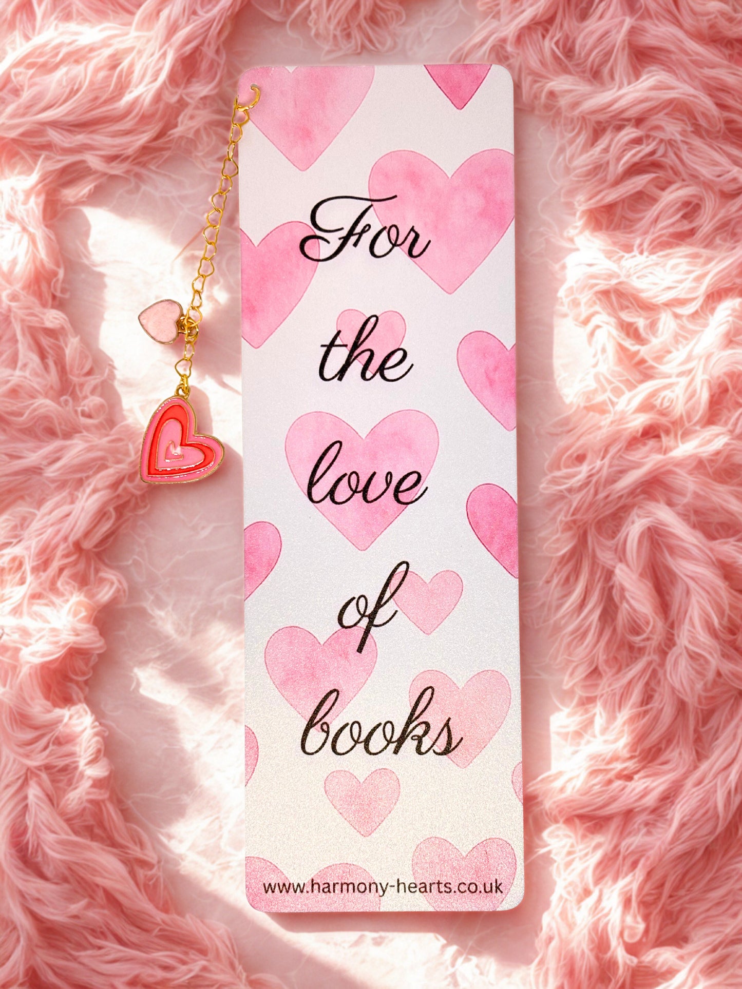 Bookmark with heart design and text 'For the love of books' on a pink fluffy background
