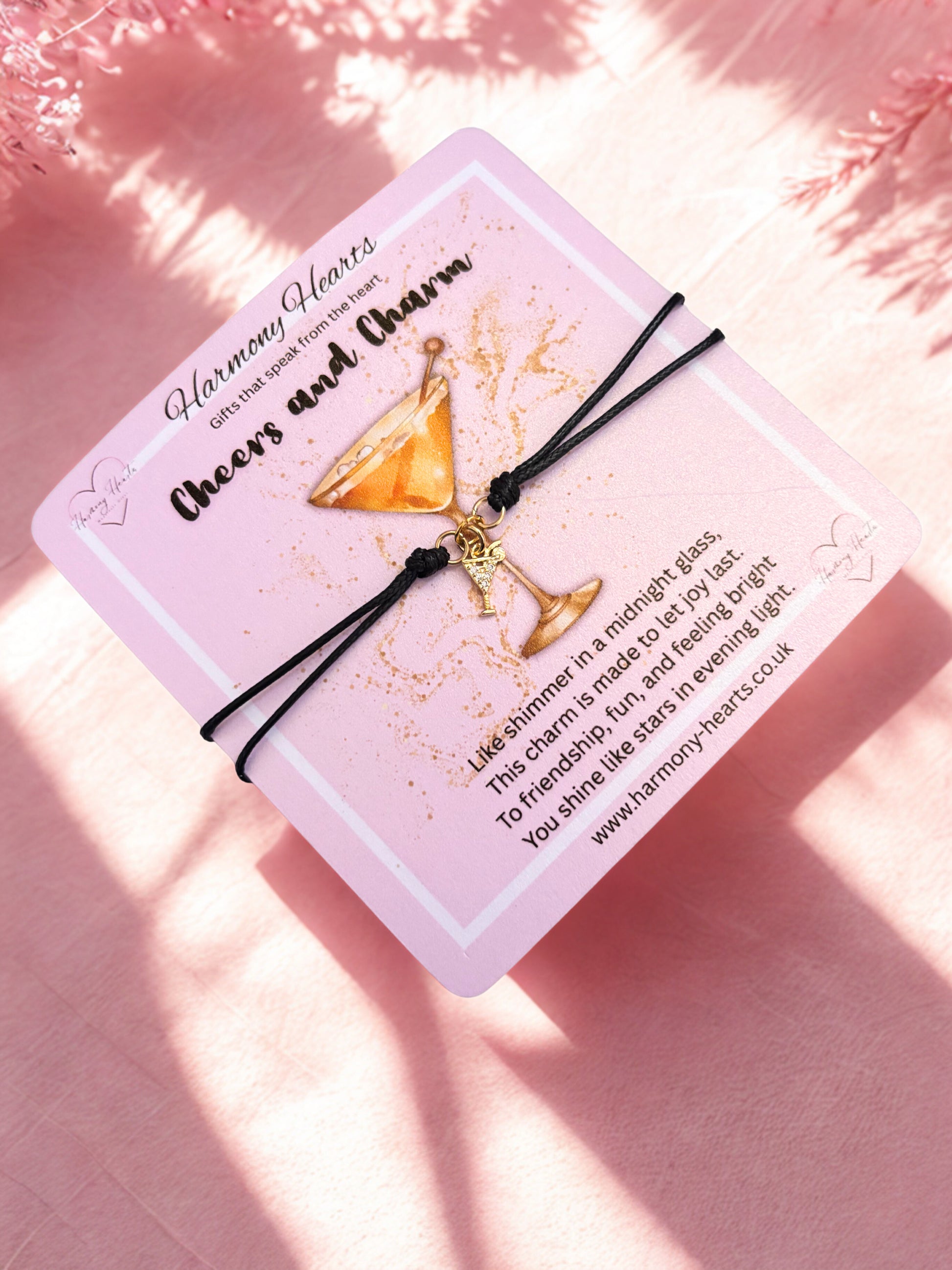Bracelet with gold cocktail charm on a pink poem card with text