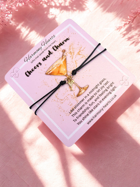 Bracelet with gold cocktail charm on a pink poem card with text