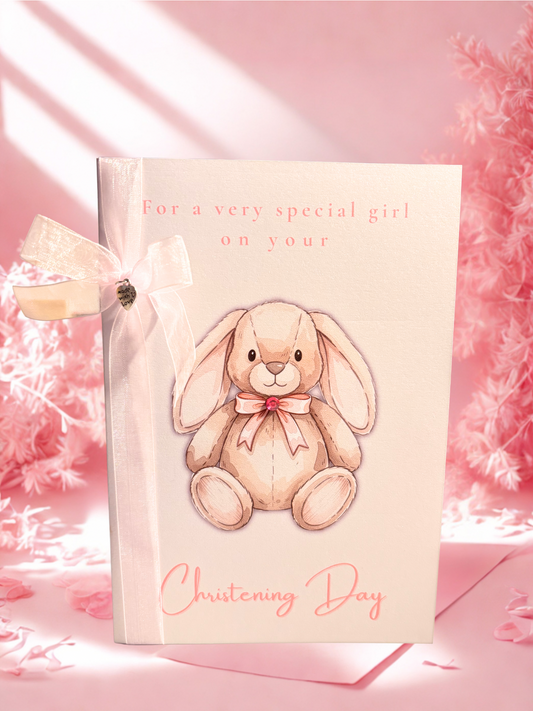 Christening card with a bunny illustration and text on a pink background