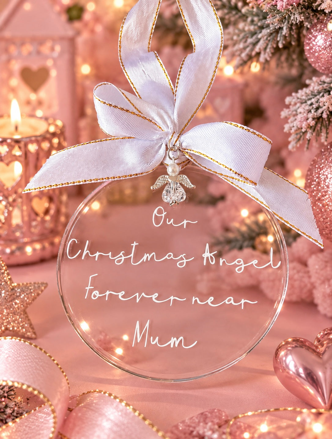Round acrylic Christmas bauble saying Our Christmas Angel forever near Mum and an angel charm and satin bow