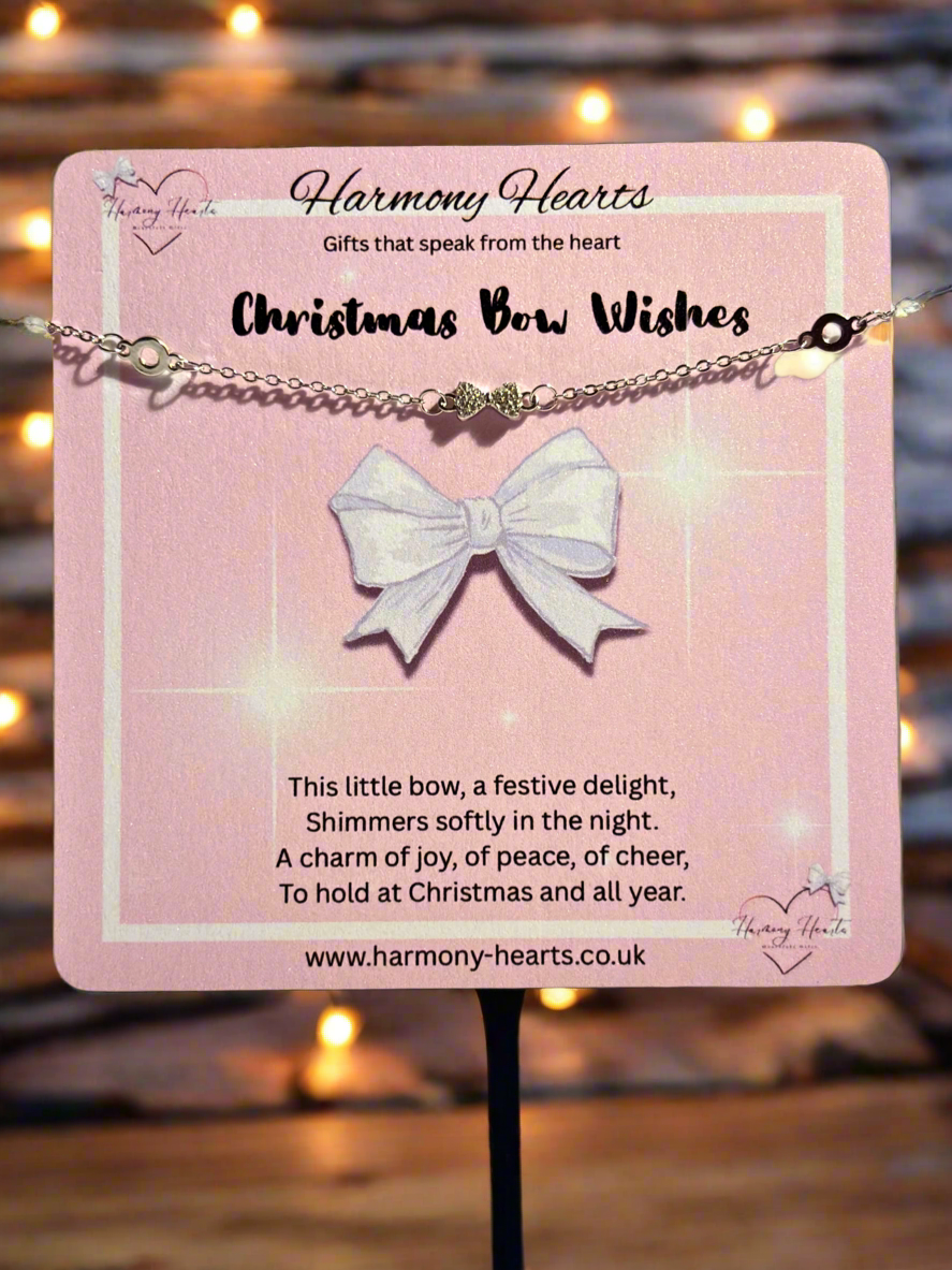 Bracelet with a bow pendant on a pink card with text, brand 'Harmony Hearts' visible.