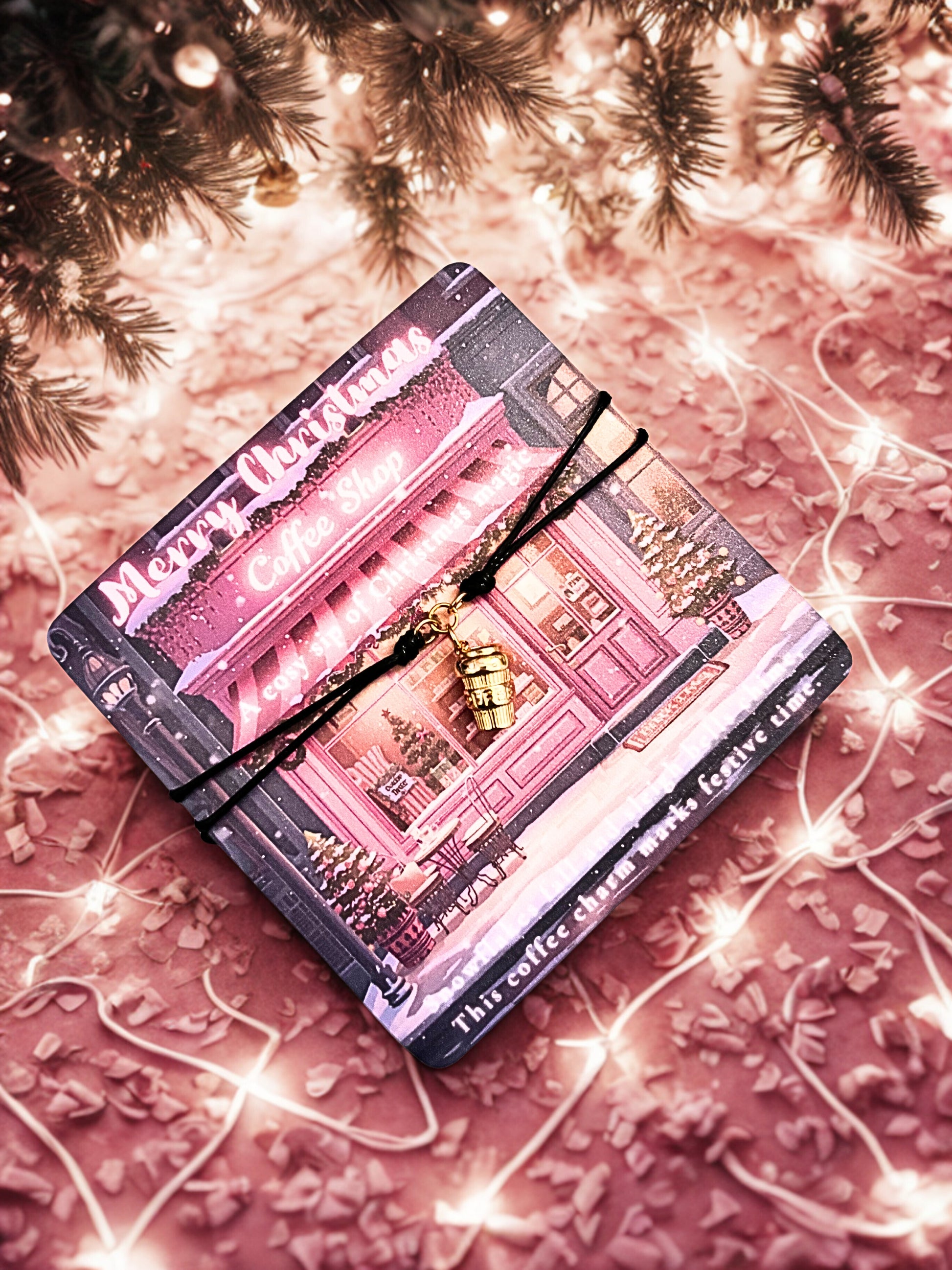 Festive poem card with a gold coffee cup charm bracelet and 'Merry Christmas' text, on a pink textured background with string lights.