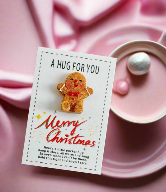 Gingerbread man plush toy on a Christmas card with a pink background