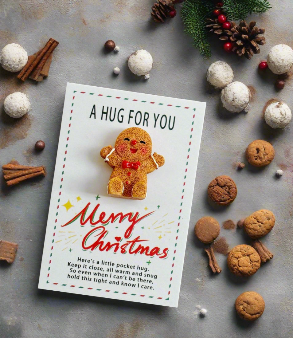 Greeting card with gingerbread man illustration surrounded by Christmas-themed items on a textured surface.