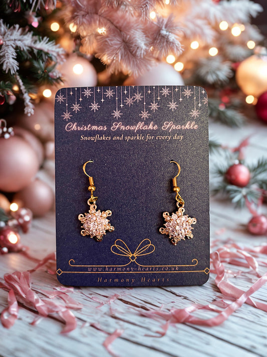 Snowflake earrings on a card with Christmas decorations in the background
