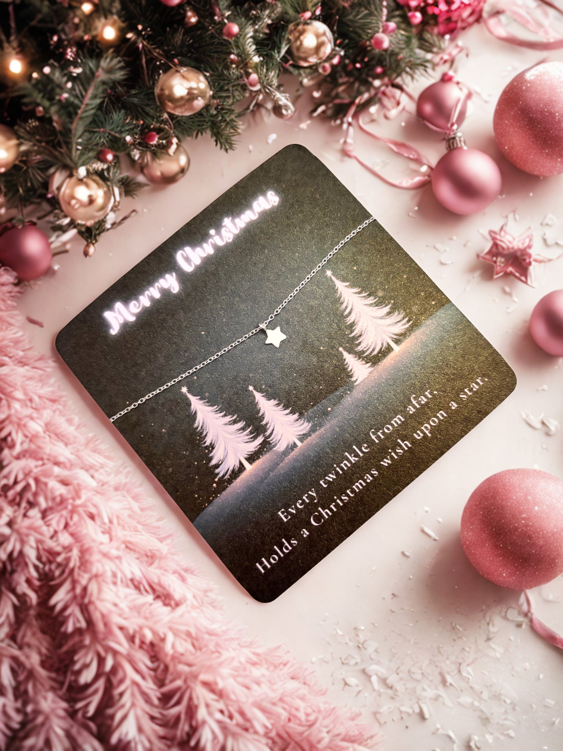 Silver star bracelet on a decorative Christmas card with trees and text on a festive background with ornaments.