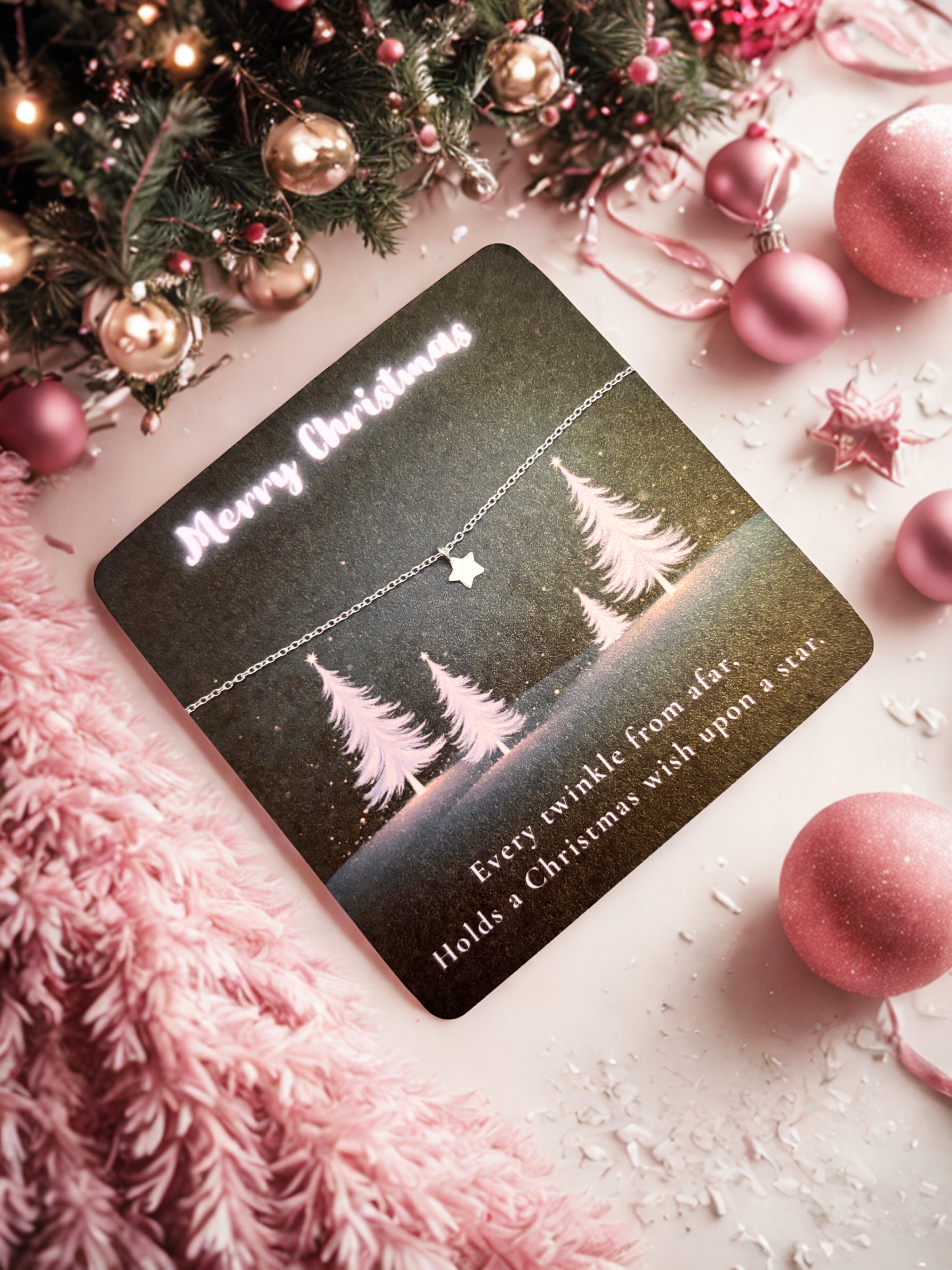 Silver star bracelet on a decorative Christmas card with trees and text on a festive background with ornaments.