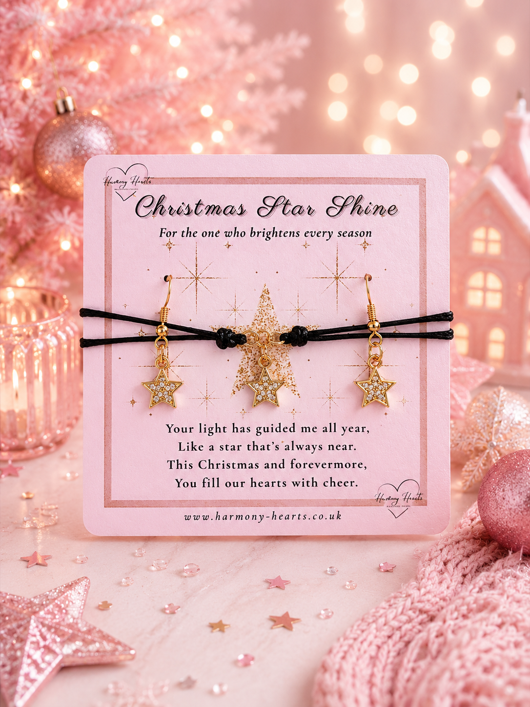 A pair of gold star-shaped dangle earrings with rhinestone accents, displayed on a pink card with black elastic bands. The card is titled 'Christmas Star Shine' and features a poem.