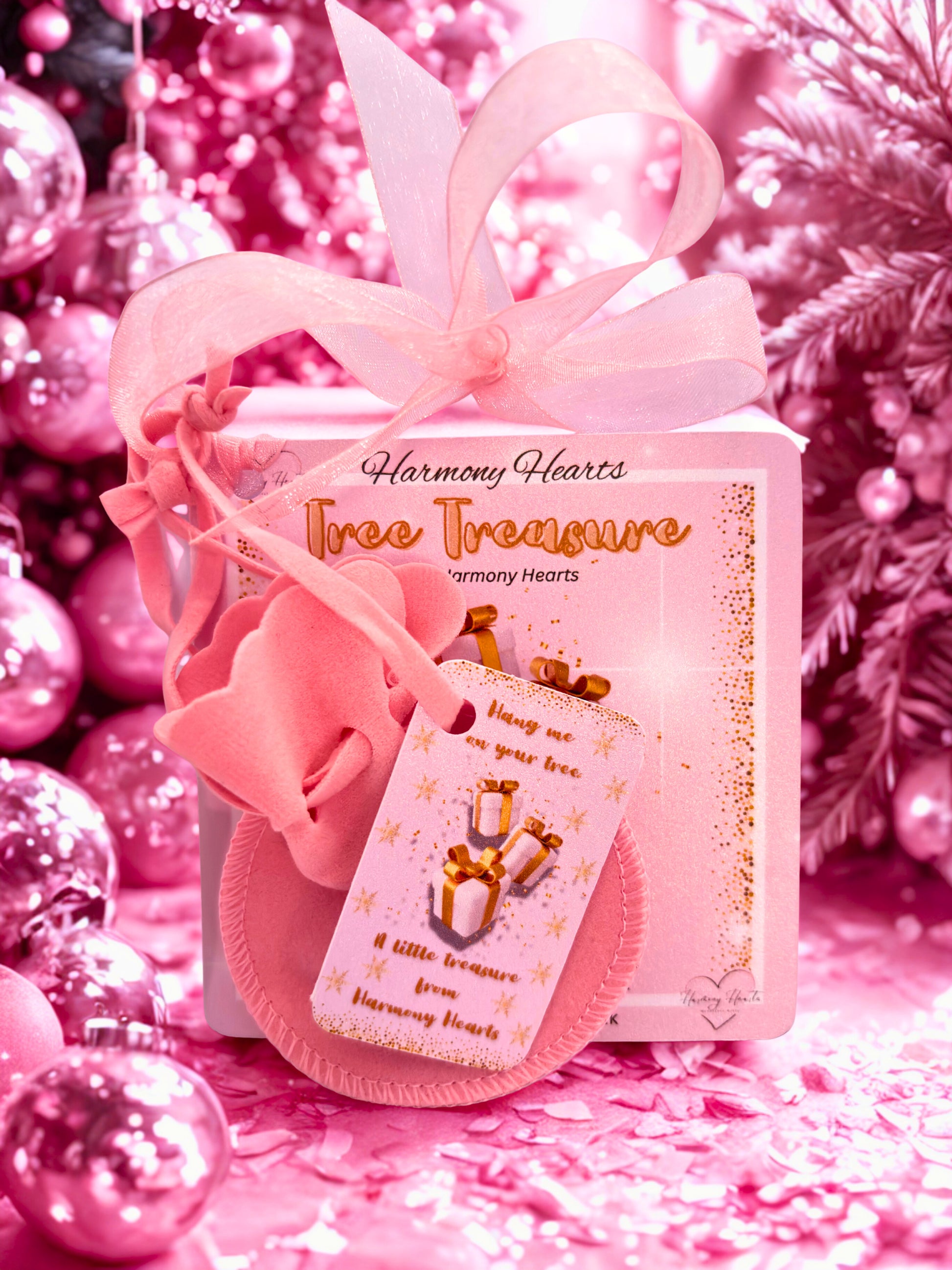 Pink gift box with 'Harmony Hearts' branding on a pink background with decorative elements.