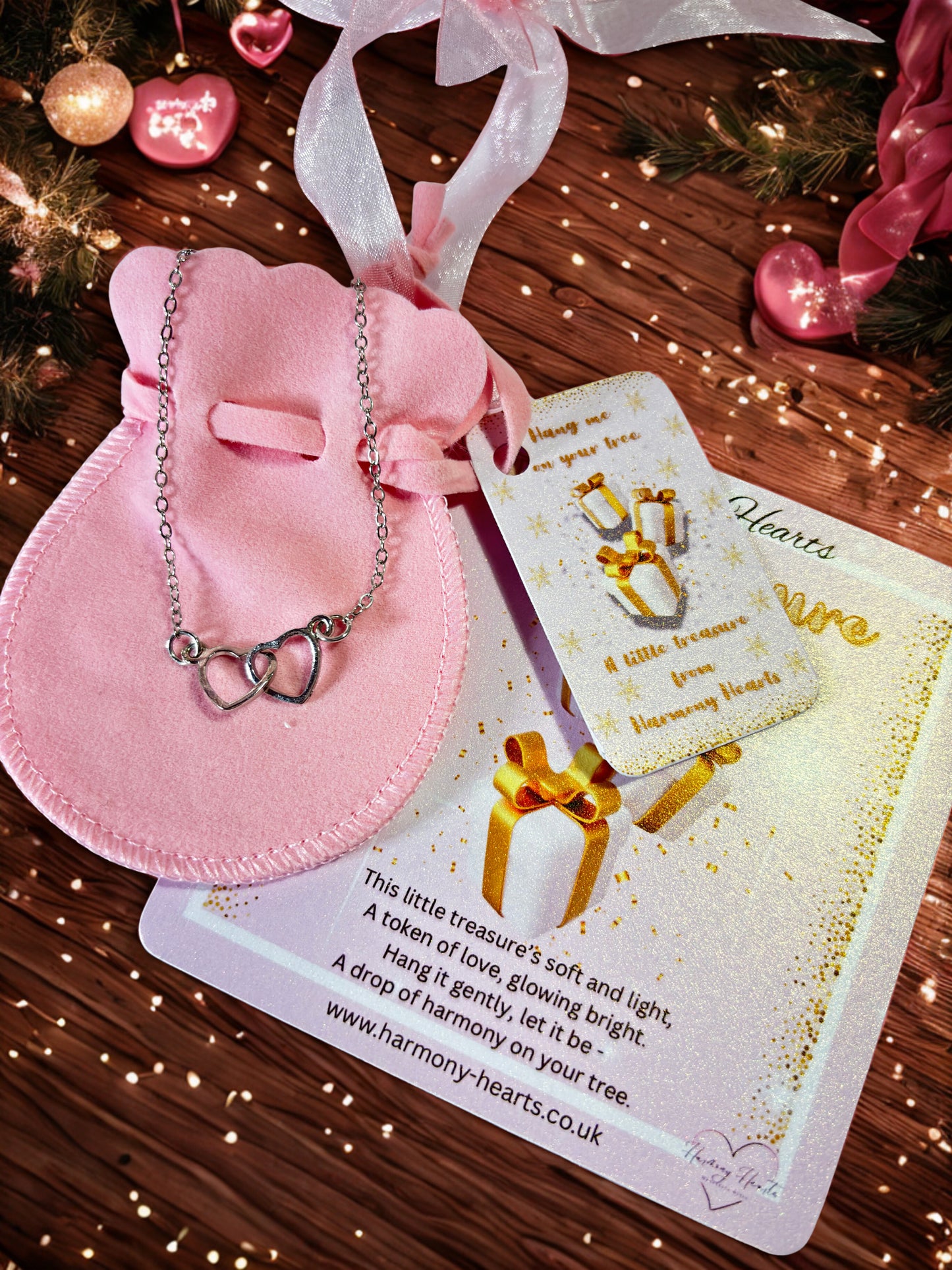Heart bracelet on a pink pouch with poem card under a Christmas tree