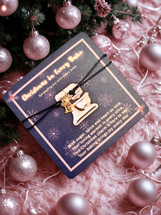 Decorative card with a gold food mixer charm on a pink textured background with Christmas ornaments.