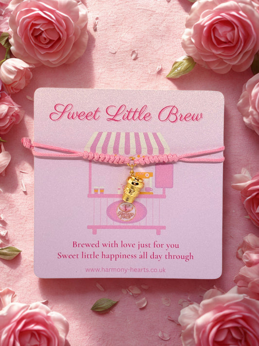 Pink bracelet with gold coffee charm on a Harmony Hearts branded card surrounded by pink roses
