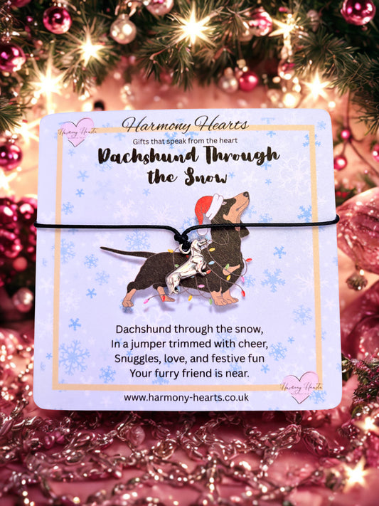 Bracelet with a card featuring a dachshund design, surrounded by festive decorations.