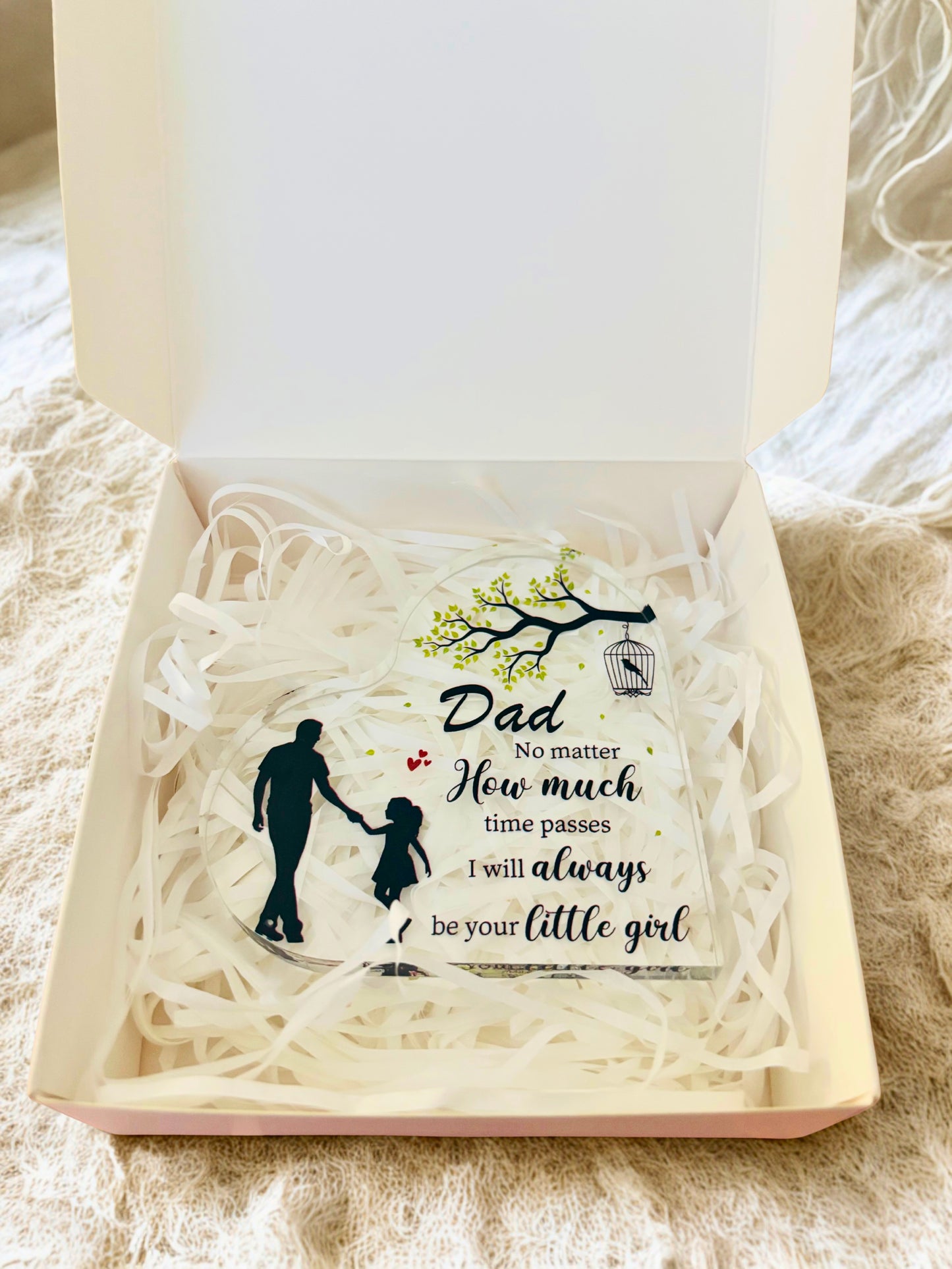 Gift box with an acrylic heart inside, featuring an engraved message and silhouette design.