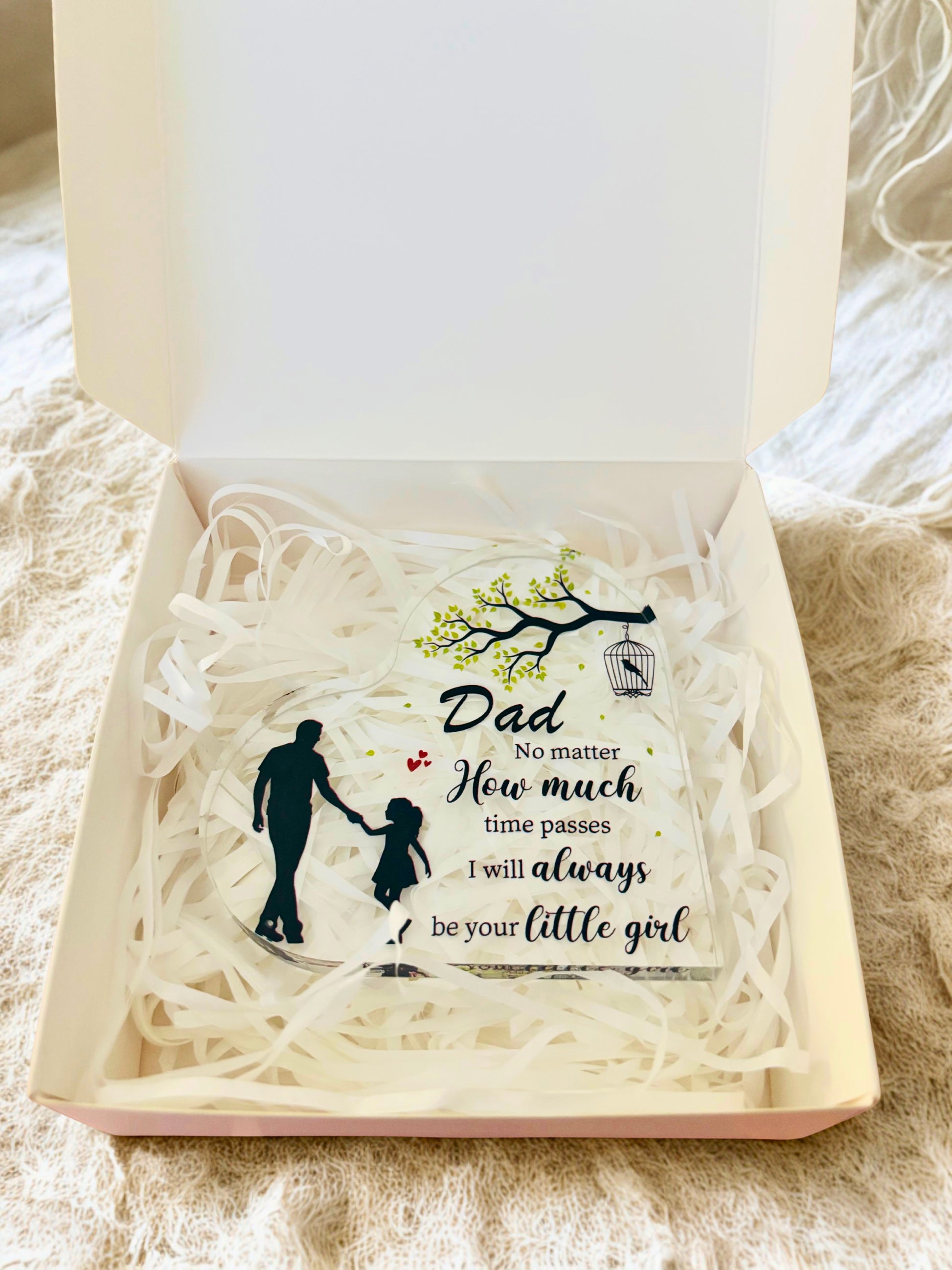 Gift box with an acrylic heart inside, featuring an engraved message and silhouette design.