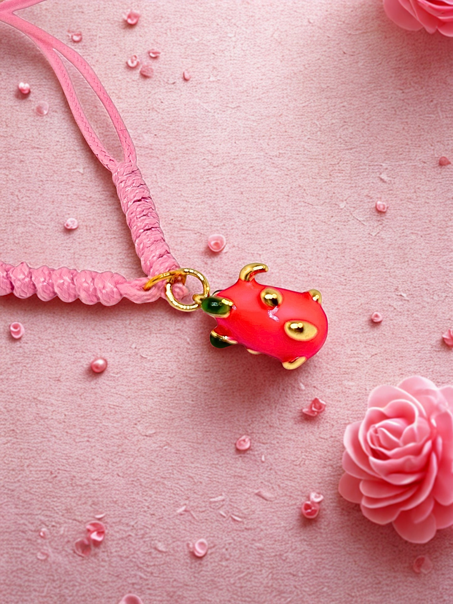 Pink cord bracelet with a pink dragon fruit charm