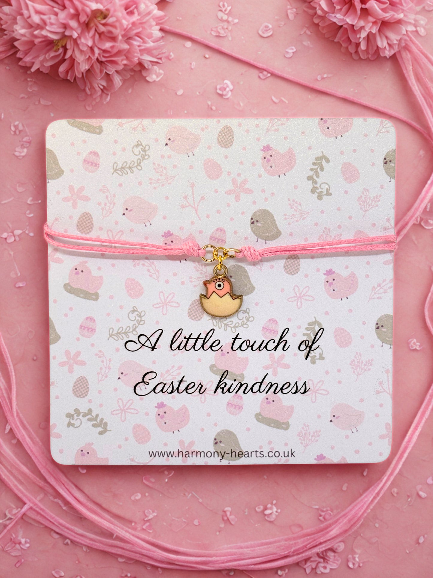 Pink charm bracelet with Easter chic design and 'A little touch of Easter kindness' text on a pink background.