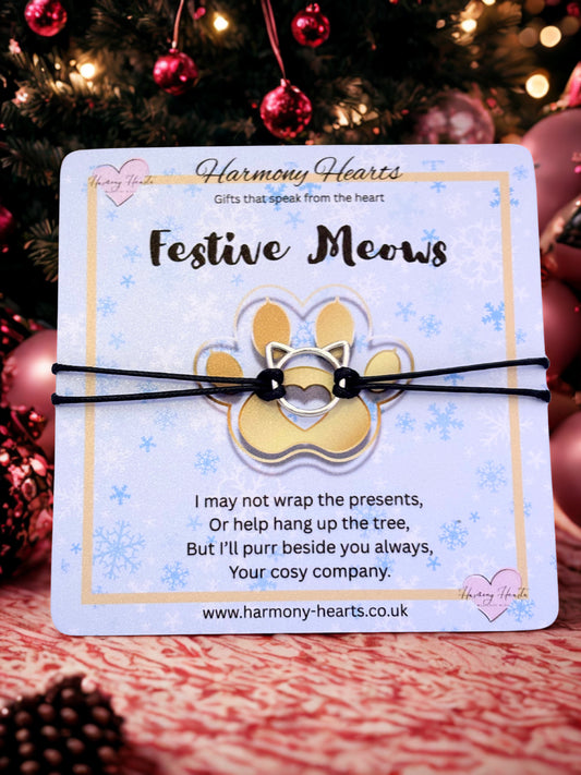 Festive Meows cat-themed product on a card with Christmas decorations in the background