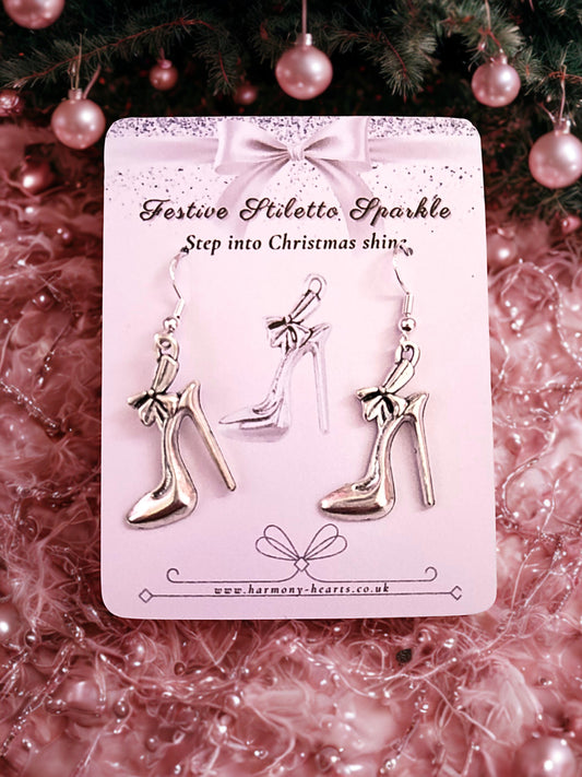 High-heeled shoe earrings on a festive card with Christmas decorations in the background