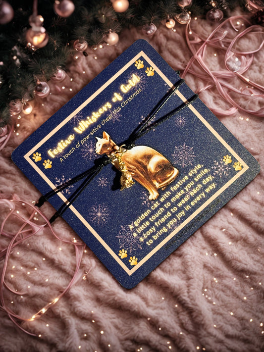 Gold cat-shaped bracelet on a blue card with decorative elements