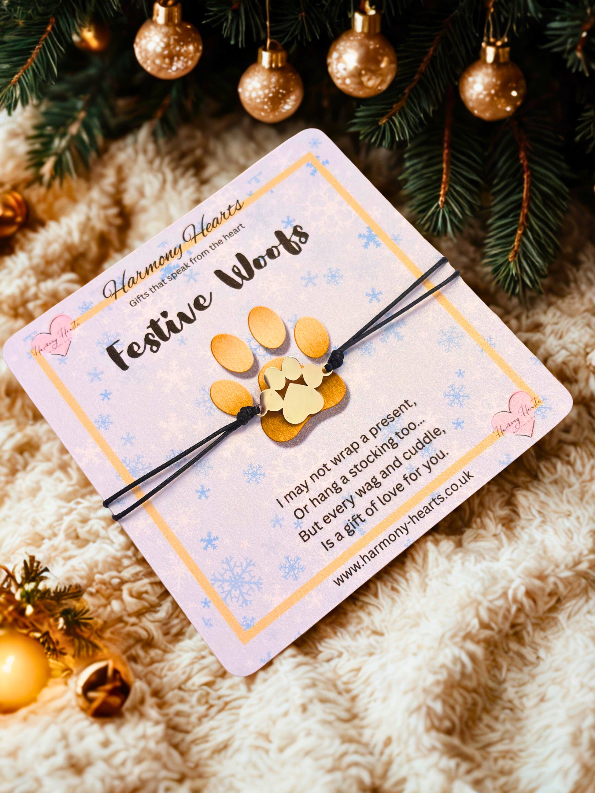 FestiveWoofs product with packaging on a soft surface with Christmas decorations.