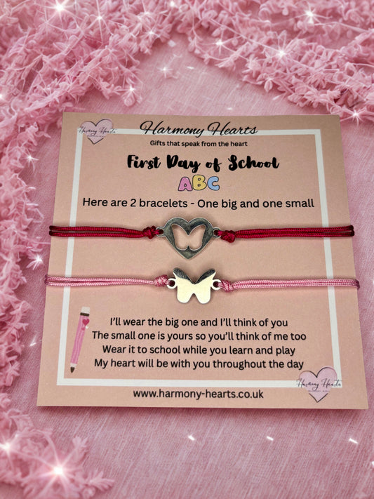 Two bracelets with heart and butterfly charms on a card with text, against a pink textured background.