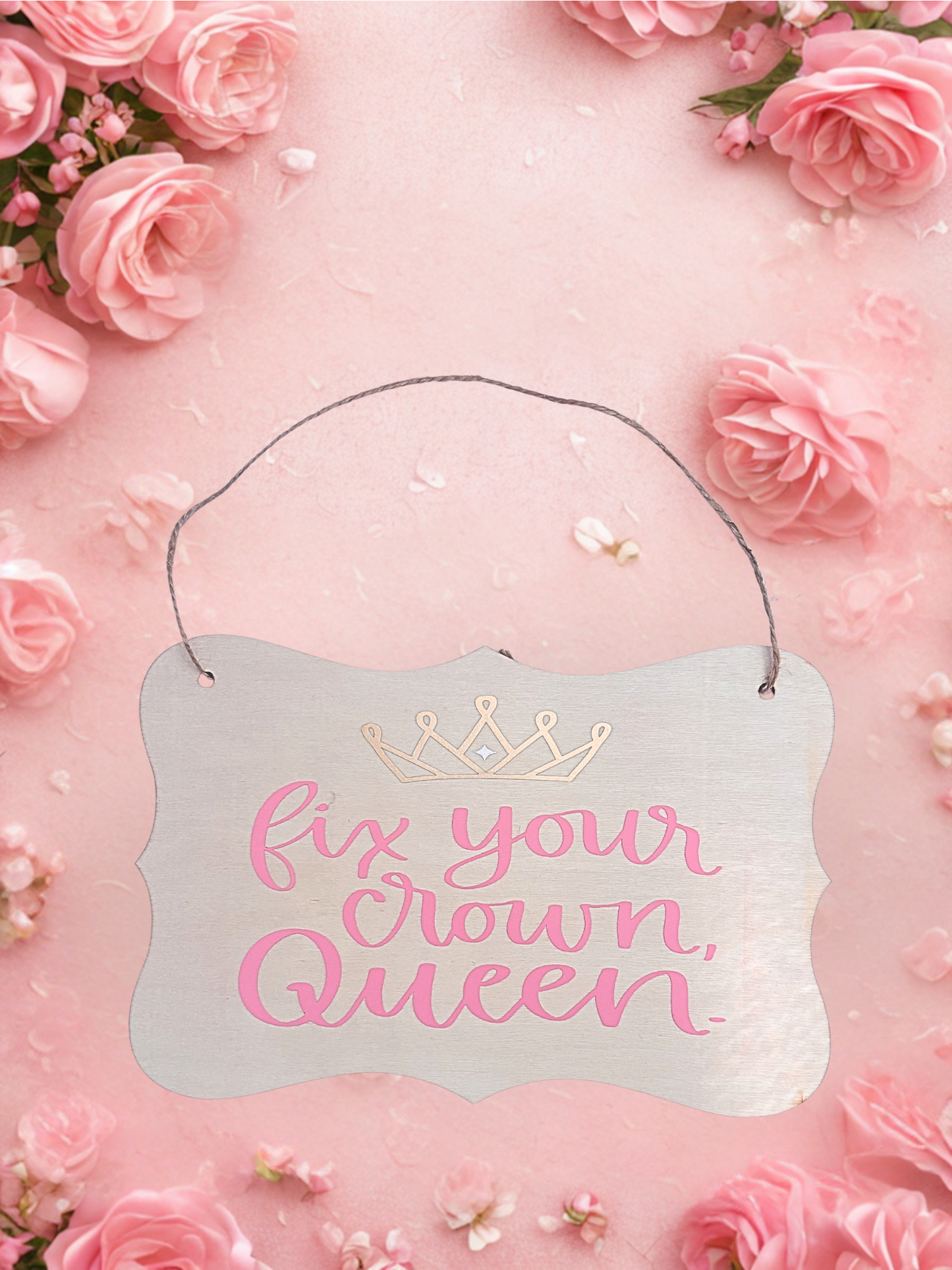 Decorative sign with 'fix your crown, Queen' text on a pink floral background