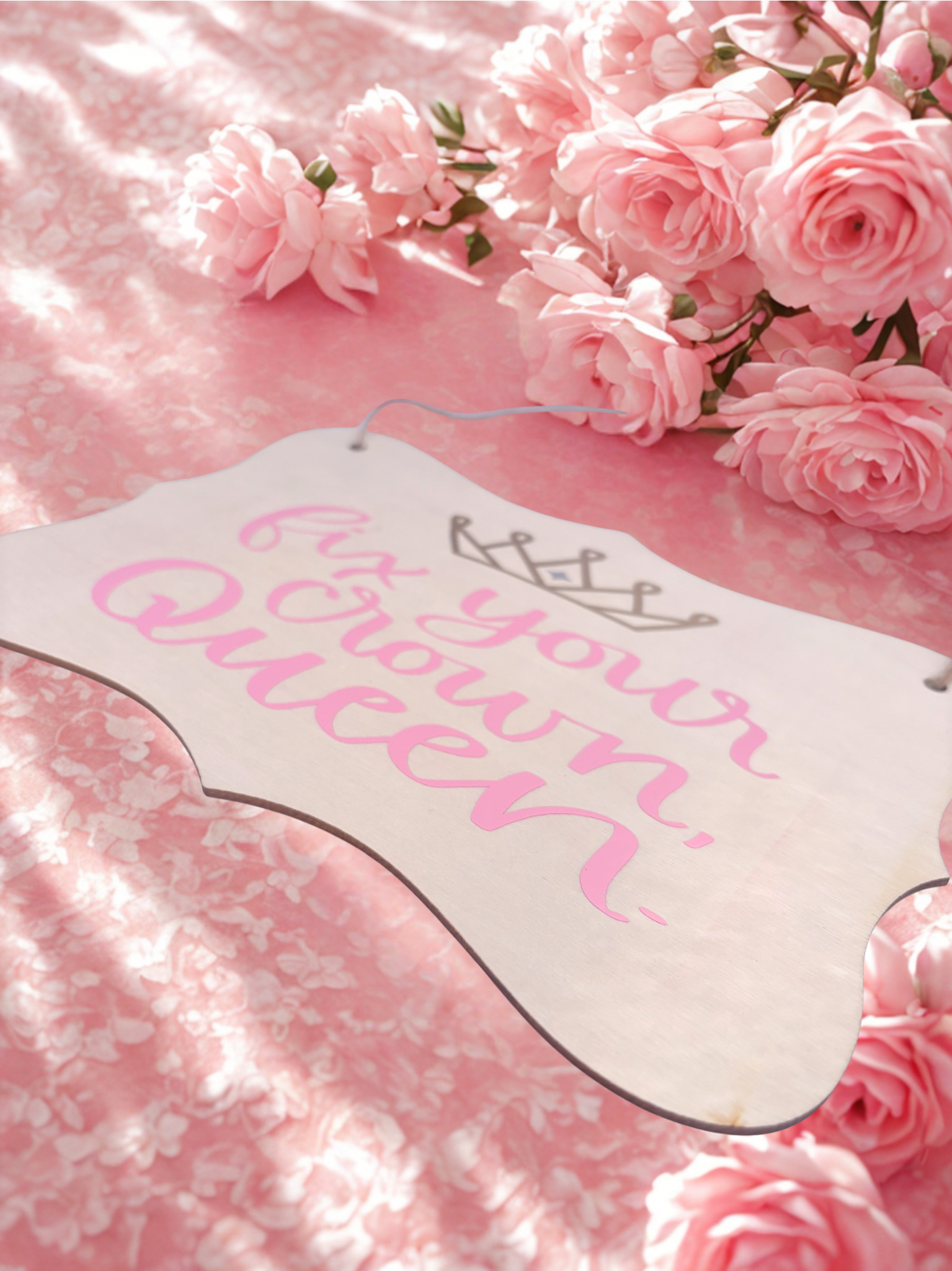 Decorative sign with 'Fix your crown queen' text on a pink floral background