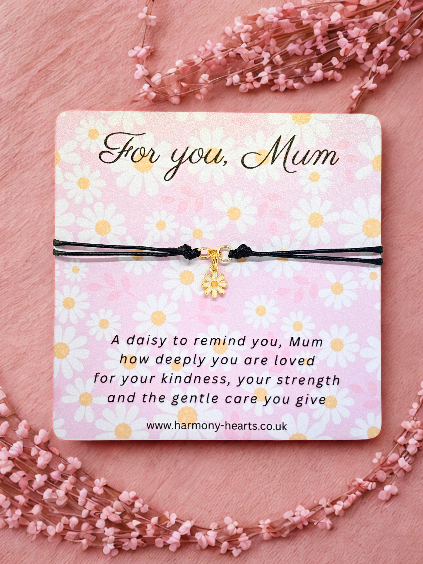 Daisy Charm Bracelet with a message card for 'Mum' on a pink floral background